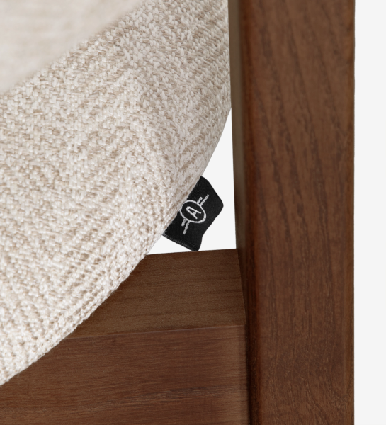 Silla con brazos, en madera de fresno color nogal, con asiento y respaldo tapizados en tela beige.