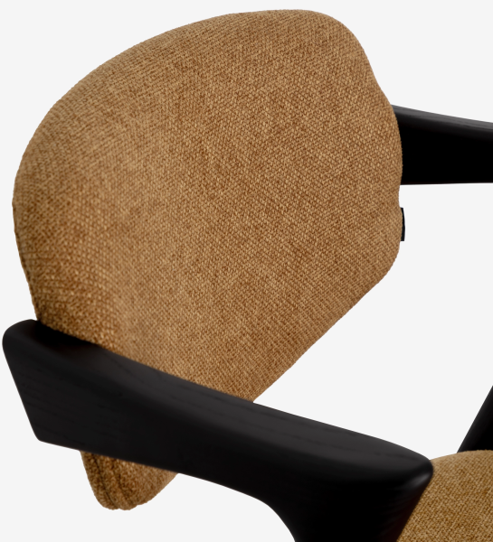 Elba Chair close-up of tan textured backrest and black wooden armrest