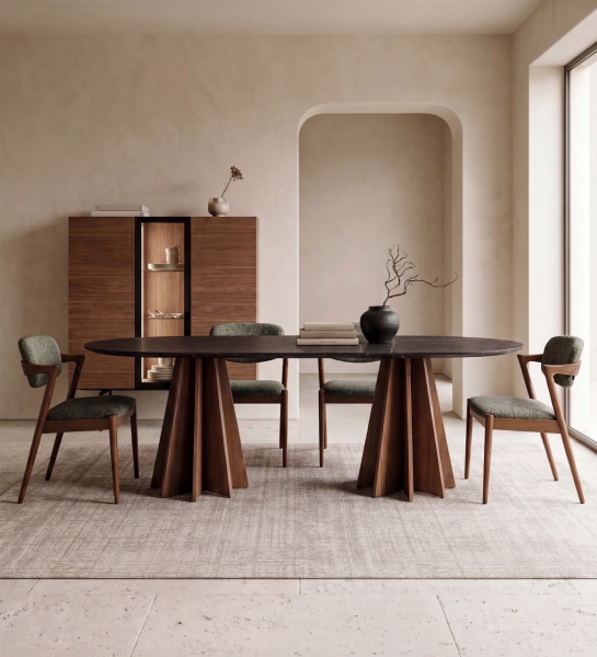 Lagos Dining Table with dark oval top and sculpted wooden pedestal bases, four chairs