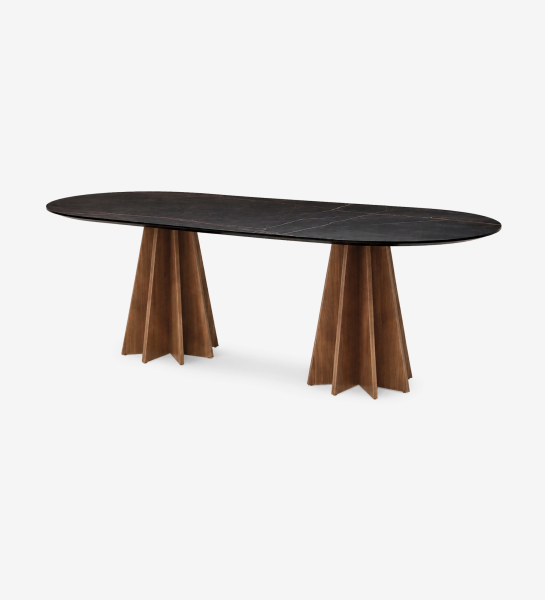 Lagos Dining Table with black oval top and two fluted wooden pedestal bases